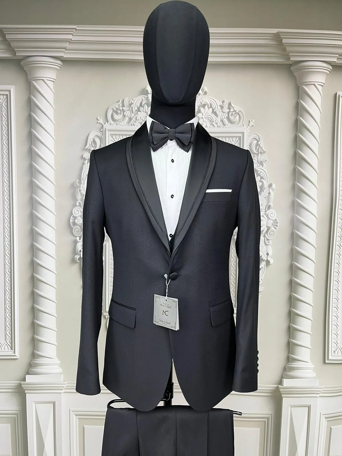 Single Button Three Pieces Tuxedo Suit with Contrasting Black Satin Lapel, matching bow tie and Black Pants.